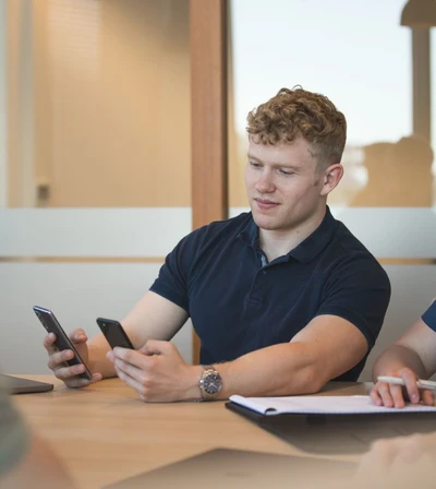 Sjoerd Lemkens holding two phones demonstrating app development